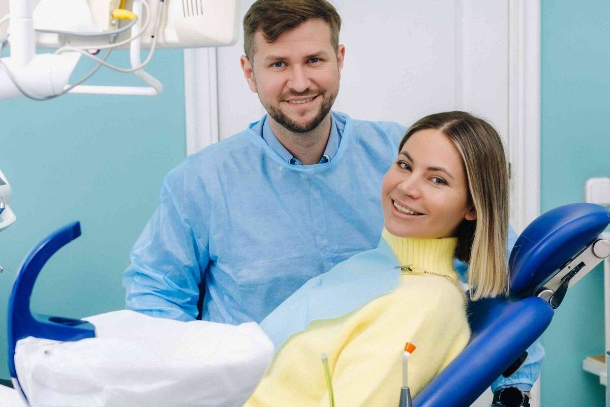 Dentist and patient discussing dental crowns for protecting a weak tooth in a dental office