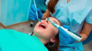A child patient undergoing a dental operation with dentist