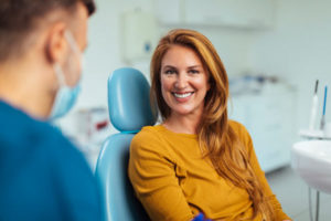 A female patient sitting in a dentist chair with her dentist 3