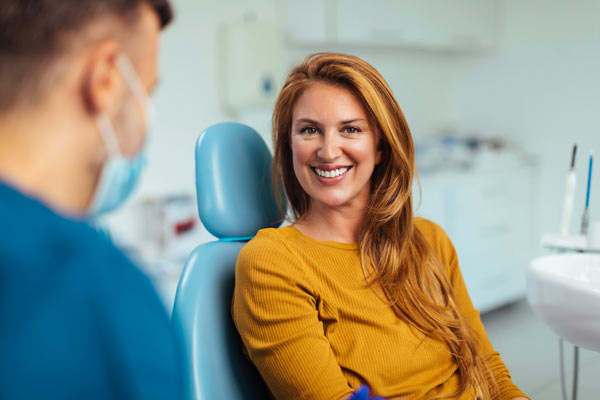 Woman smiling during her dental cleaning