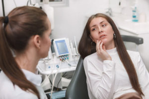 A female patient sitting in a dentist chair with her dentist 2