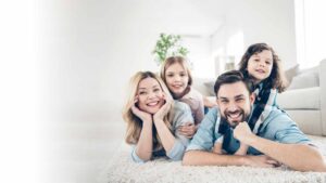 A family lying down, nodding their heads together
