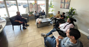 Patients seated in a bright, modern dental clinic waiting room