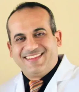 Portrait Of Handsome Male Dentist Posing In Dental Clinic.